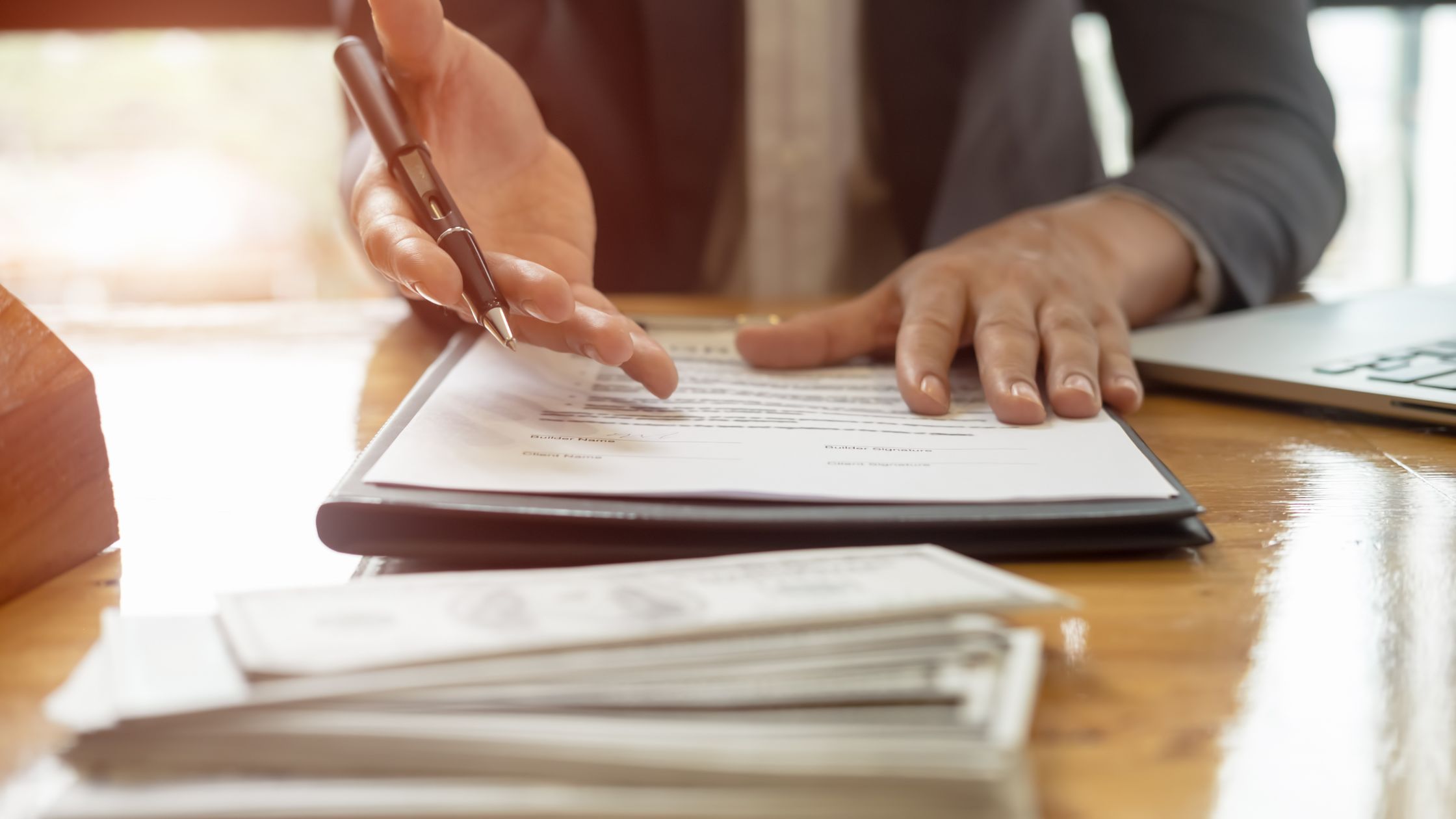 Paperwork stack with What Is an SSP for FedRAMP? The No-Drama Guide to Getting It Right